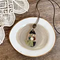 Collana etnica fatta a mano a forma di goccia con bottoni in legno e nappe verdi - Goccia d'Acqua Nera con Bottoni e Nappa / Nero