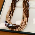 Gros plan d'un collier multi-rangs avec des perles en verre marron, dorées et argentées. - 3# Collier-Café