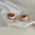 Close-up of French vintage gold hoop earrings with white enamel and clear zirconia stones. - Gold