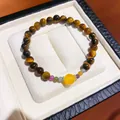 Macro view of a tiger eye beaded bracelet with colorful accents in a white jewelry box. - 9# Bracelet - Coffee - Yellow