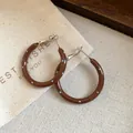 Nahaufnahme brauner Emaille-Ohrringe mit blauen Punkten und Silberstecker-Details - Silberner Ohrstecker - Kaffee