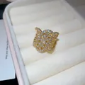 Elegant golden twisted oval open ring with sparkling white cubic zirconia accents for women - Gold