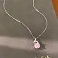 Close-up of a silver-toned necklace with a delicate pink rose-shaped zircon pendant - Choker Necklace / Silver-Pink