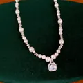 Elegant pearl necklace detail with sparkling square zircon pendant on green velvet - Square Zirconia Pearl Choker (HN13640) / 1 Piece / Silver with Pink Zirconia
