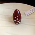 Macro close-up showing the detail of a vintage oval red enamel ring with inlaid rhinestones - Red - Large