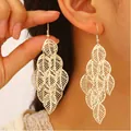 Exaggerated gold-tone layered leaf dangling earrings with a textured bohemian finish - Hollow Multi-layer Leaf Shape (8595) / Gold