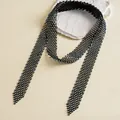 Close-up detail of luxury black woven necktie necklace with iridescent rhinestones in soft light - Black-AB Color