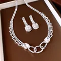 Detailed view of luxury silver-toned jewelry set with oval stones and pavé crystals - Necklace And Earrings / Silver-White