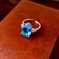 Close-up of elegant oval blue zircon ring on a textured leather surface - Ring / Silver/Blue