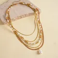 Detailansicht einer mehrlagigen Goldhalskette im Vintage-Stil mit Barockperlen - Gold