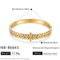 Close-up detail of flower patterned stainless steel bangle with gold finish and rhinestones. - Flower Pattern Bangle (NB-B6643) / 18K Gold / Gold