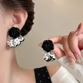 Detailed view of black rose earrings featuring white polka-dot fabric skirt - Rose Polka Dot Skirt Style / Silver Needle-White-Black
