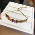 Close-up of 18k gold plated bracelet with vibrant colorful oval zirconia stones - Rainbow Oval Style (12#)