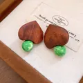 Macro detail of vintage wooden heart earrings featuring unique green marbled bead accents. - Coffee-Green (7#)