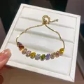 Detailed macro view of an 18k gold-plated bracelet with multi-colored zirconia stones. - Vertical Geometric Style (3#)