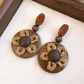 Detailed macro view of retro wooden earrings featuring a woven straw flower on canvas - Bohemian Woven Straw Flower Disc Style (13#) / Coffee (13#)