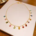 Detail view of a gold-tone necklace featuring vibrant geometric multi-color zircons. - Gold-Multicolor