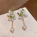 Elegant vintage floral drop earrings featuring white resin flowers pearls and crystal butterflies - Silver Pin-Gold-White