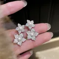 Detailed macro view of silver needle flower earrings with pavé crystals and pearls. - Flower Style (HE35786) / Silver