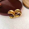 Macro detail of luxury 18K gold plated retro hoop earrings with tiger eye resin beads. - Curved Metal with Bead (3#) / Gold with Coffee