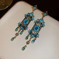 Vue détaillée de boucles d'oreilles bohèmes vintage avec strass bleus et des glands - Style Gland Bohême Vintage / Bleu