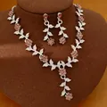 Elegant silver jewelry set featuring pink crystal flowers and leaves on a brown display - Necklace and Earrings Set / Silver-Dark Pink