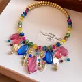 Vue détaillée d'un collier de perles en acrylique coloré avec des breloques dorées - Geometric Collar Necklace / Or-Multicolore