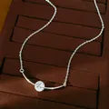 Close-up of silver-tone curved necklace with round clear zircon on brown velvet tray. - Zirconia Round Curved Pendant / Silver