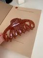 Detail of a large acrylic hair claw clip with a glossy brown leopard print pattern - Large Claw Clip / Coffee Gradient