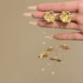 Close-up of gold flower tassel earrings with delicate bead details on long chains - Gold