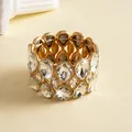 Detailed close-up of a gold-tone luxury elastic bracelet with double-layer teardrop crystals - Gold