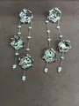 Elegant silver metal flower tassel earrings with delicate white bead accents. - Silver