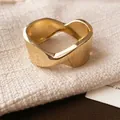 Detailed close-up of a gold wavy metal open bangle with irregular folded texture - 4# Bangle Gold Shiny Wrinkled