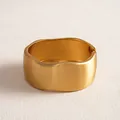 Macro detail of a wide matte gold irregular geometric bangle with a brushed finish - Wide Style / Matte Gold