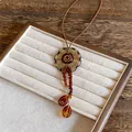 Macro view of vintage acrylic circular pendant with amber bead tassels on wax rope - Spiral Round Style (2项链-咖色) / Coffee