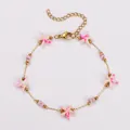 Charmantes goldenes Ozean-Armband mit rosa Seesternen und Perlen aus Stahl - Armband / Rosa Weiß