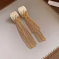 Detailed view of elegant gold pleated square stud earrings with long chain tassels - Gold