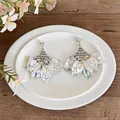 Close-up of forest style earrings with acrylic petals and cat-eye stones on a white plate - Silver Earring Post-White