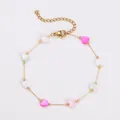 Macro detail view of elegant gold chain bracelet featuring colorful heart-shaped shell beads - Heart Bracelet / Gold