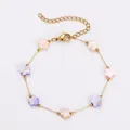 Detail of a stainless steel gold bracelet with colorful pastel shell flower charms - Flower Bracelet / Gold