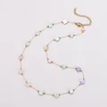 Close-up of colorful shell flower charms on a delicate gold stainless steel necklace - Flower Necklace / Gold
