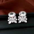 Close-up of silver-tone flower stud earrings with oval and marquise clear crystals. - Stud Earrings / Silver