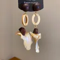Detailed view of retro ethnic wood and shell drop earrings with silver needles - Round / Silver Earring Post - Coffee