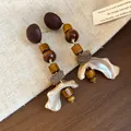 Close-up of retro ethnic wooden and shell drop earrings on a linen background - Square / Silver Earring Post - Coffee