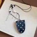 Close-up of polka dot leather glasses holder necklace with stylish decorative beads - Black