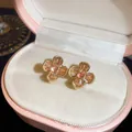 Elegant vintage floral clip-on earrings with champagne zircons in a pink gift box. - Clip-On Earrings / Gold Brown