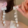 Elegante Franse pareloorbellen met vlinderstrikje en lange kwastjes met schelpjes - Parel Strik Bloemblaadje Kwast Stijl (28#)