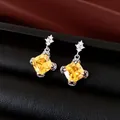 Elegant silver needle earrings featuring cushion-cut yellow zircon stones. - Silver Needle Studs / Yellow