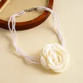 Detail of vintage multi-strand pearl necklace with large white fabric rose flower - Light Yellow