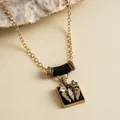 Macro view of vintage butterfly pendant necklace with black enamel and sparkly rhinestones - Butterfly Pendant Necklace / Gold/Black